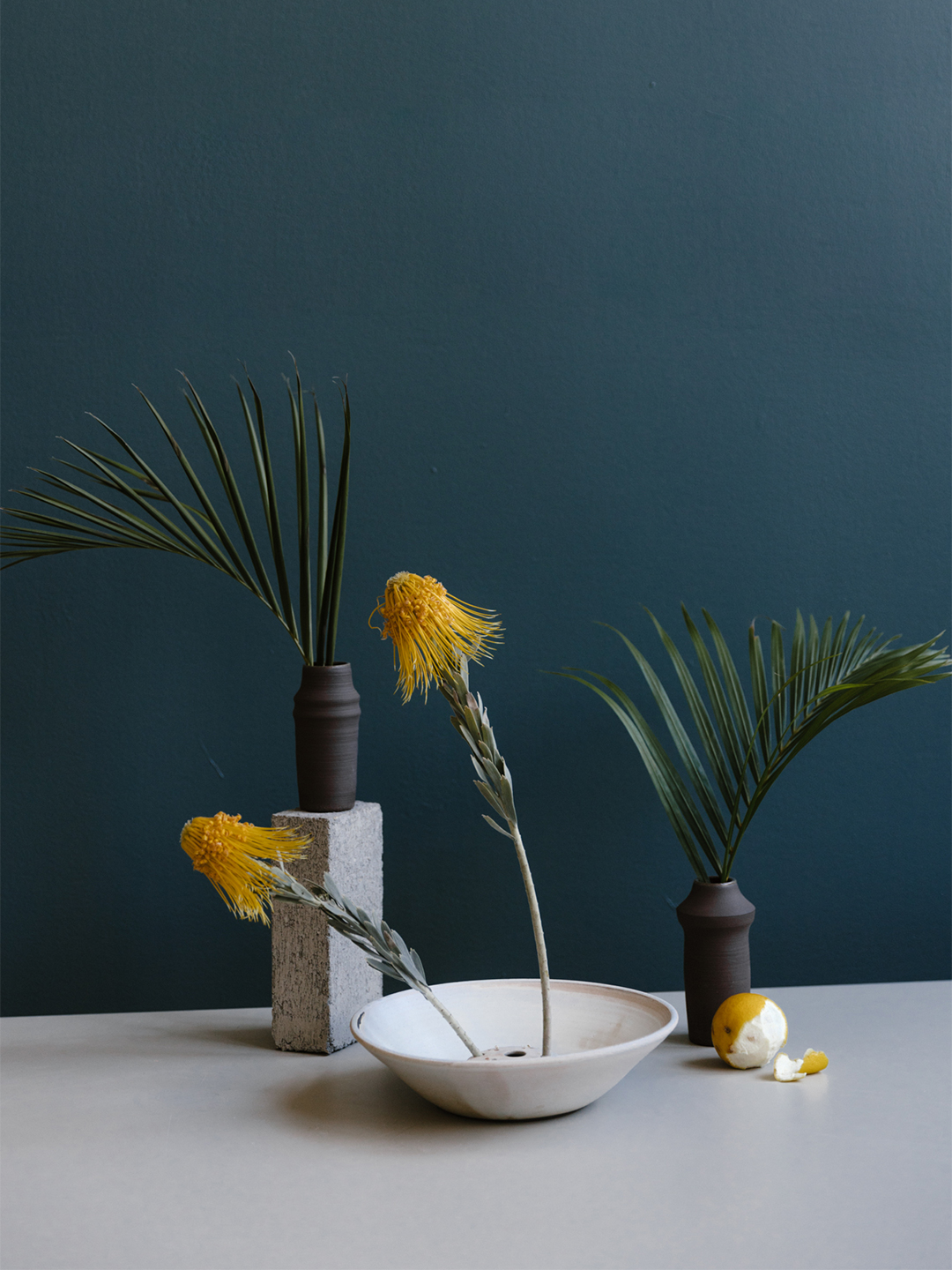 blue wall with flowers in vases