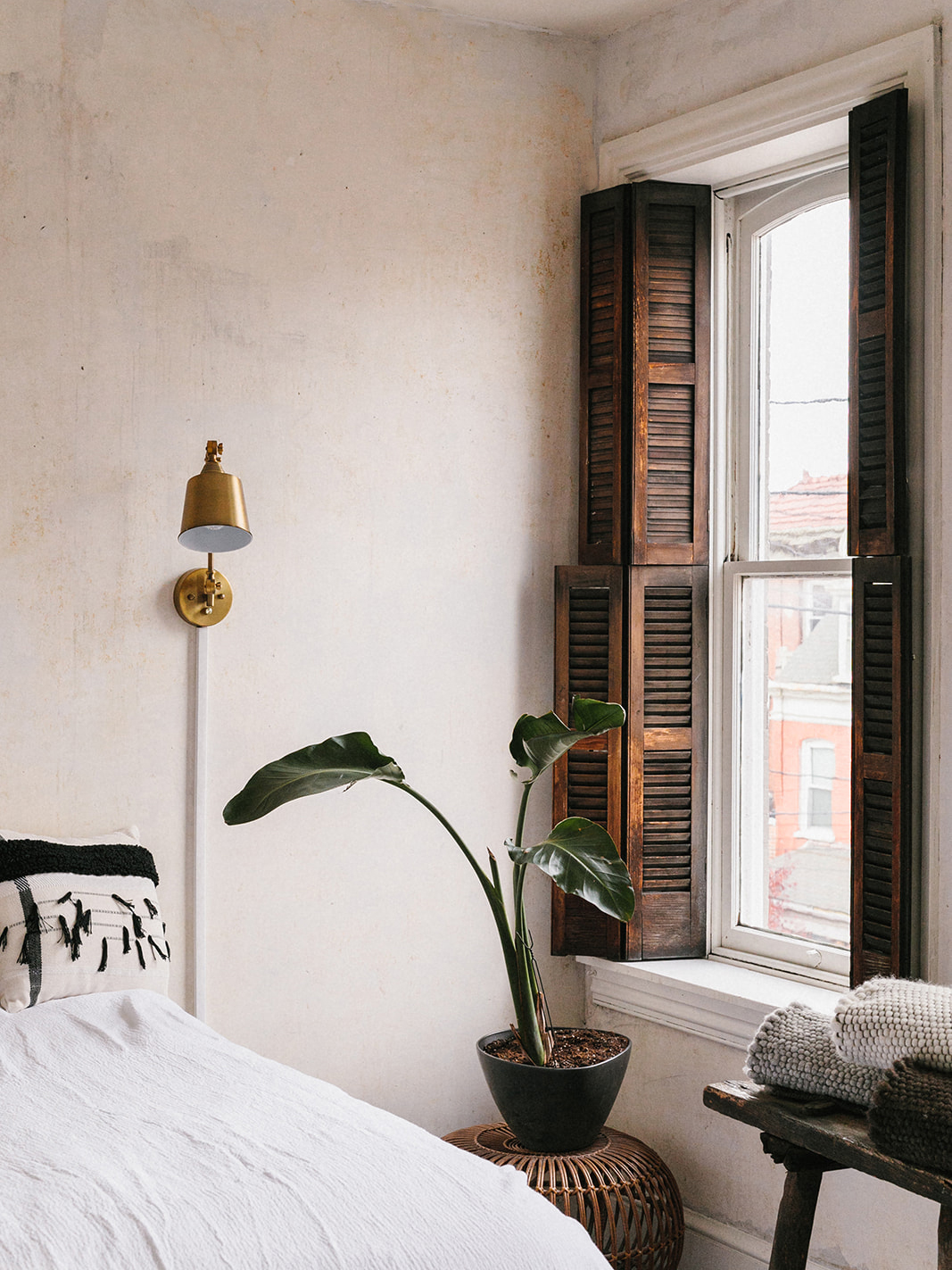 old wood shutters in a white bedroom