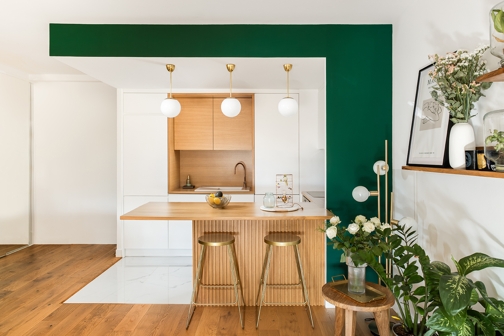 green and white kitchen with bar seating