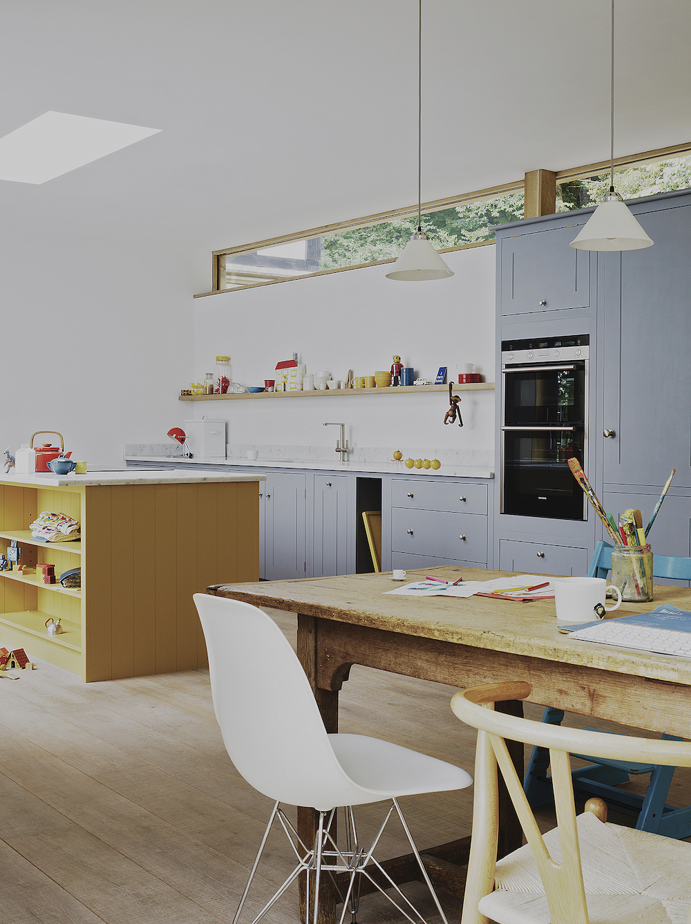 wood kitchen dinging table and gray cabinets