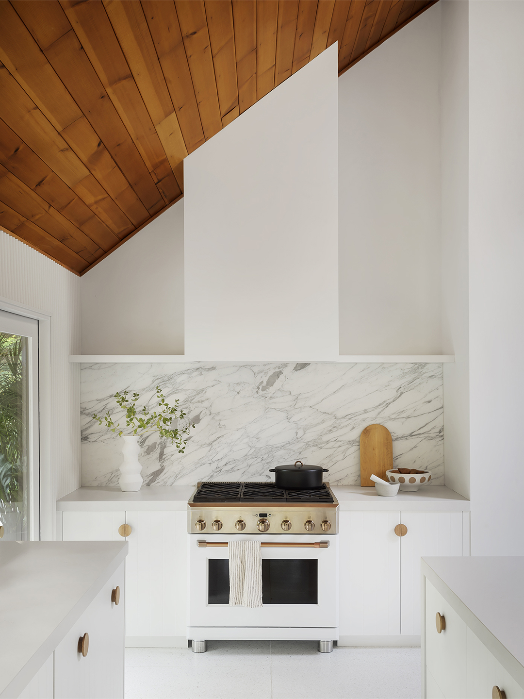 slanted wood roof with white and marble range