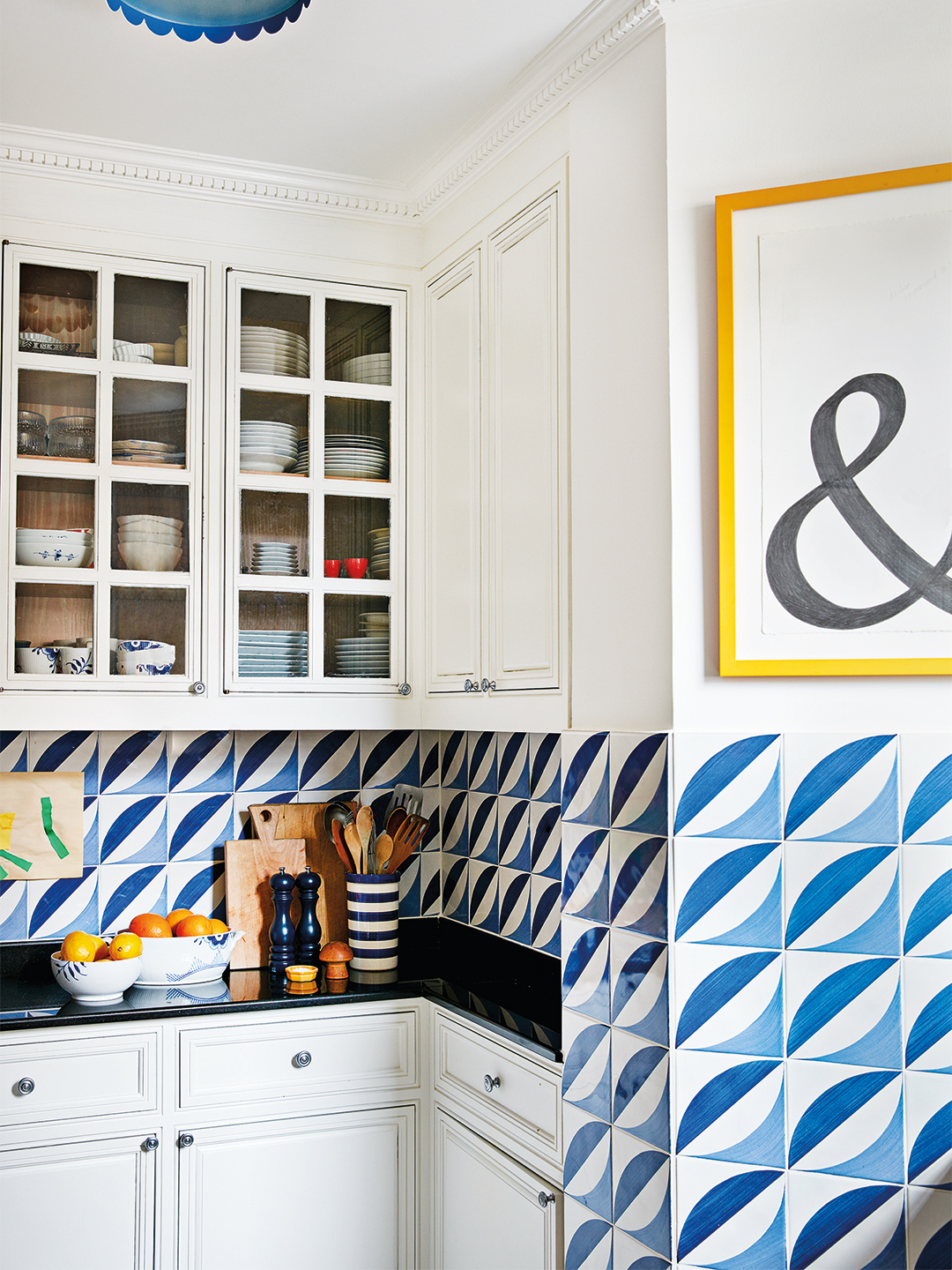 wavy blue tiles extending from backsplash to wall