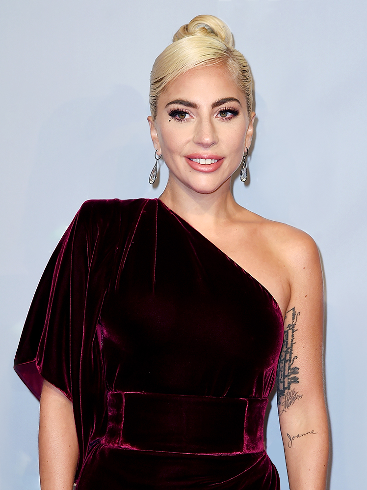 Lady Gaga in a red velvet one shoulder dress