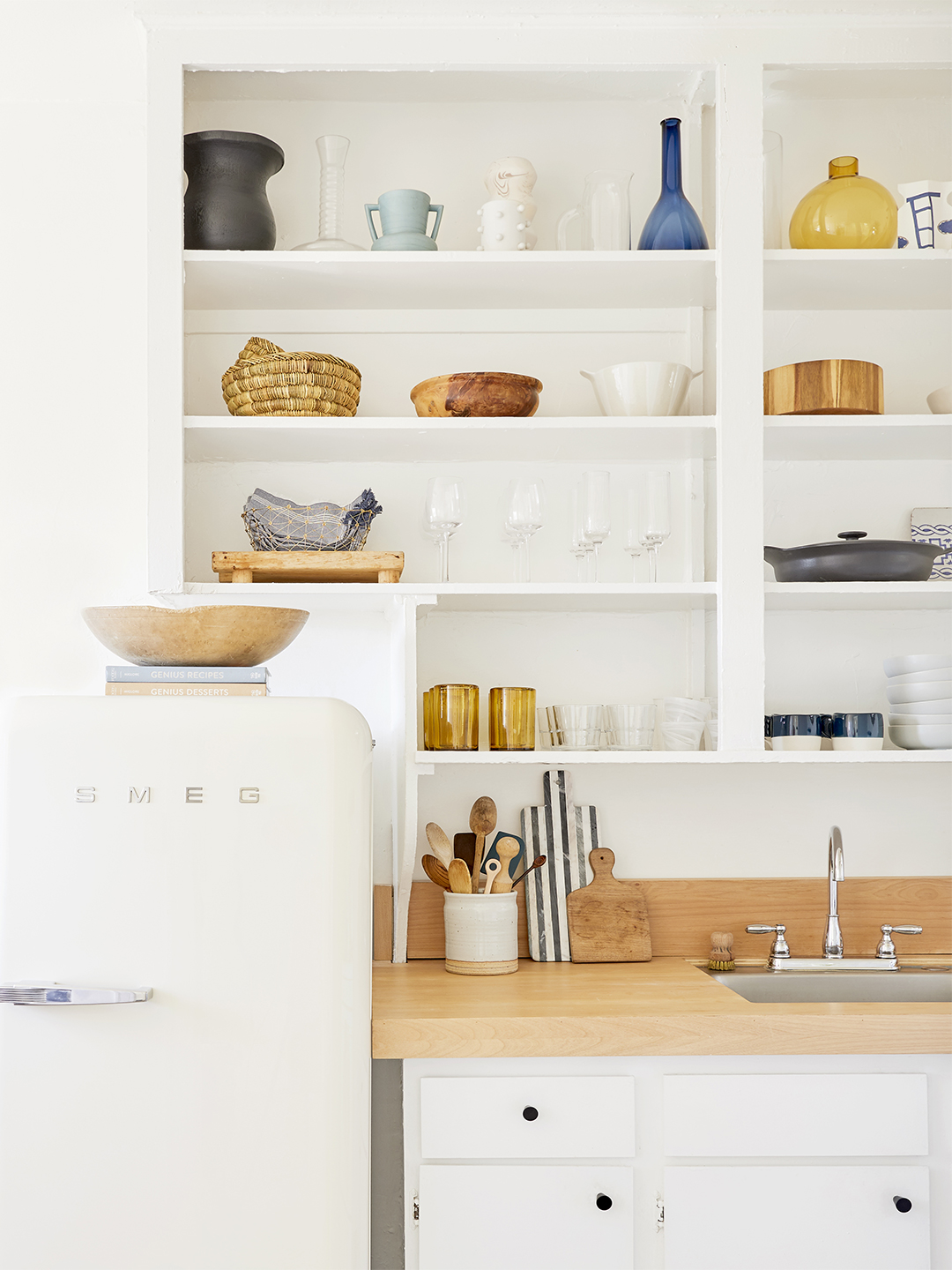 white doorless kitchen cabinets and smeg fridge