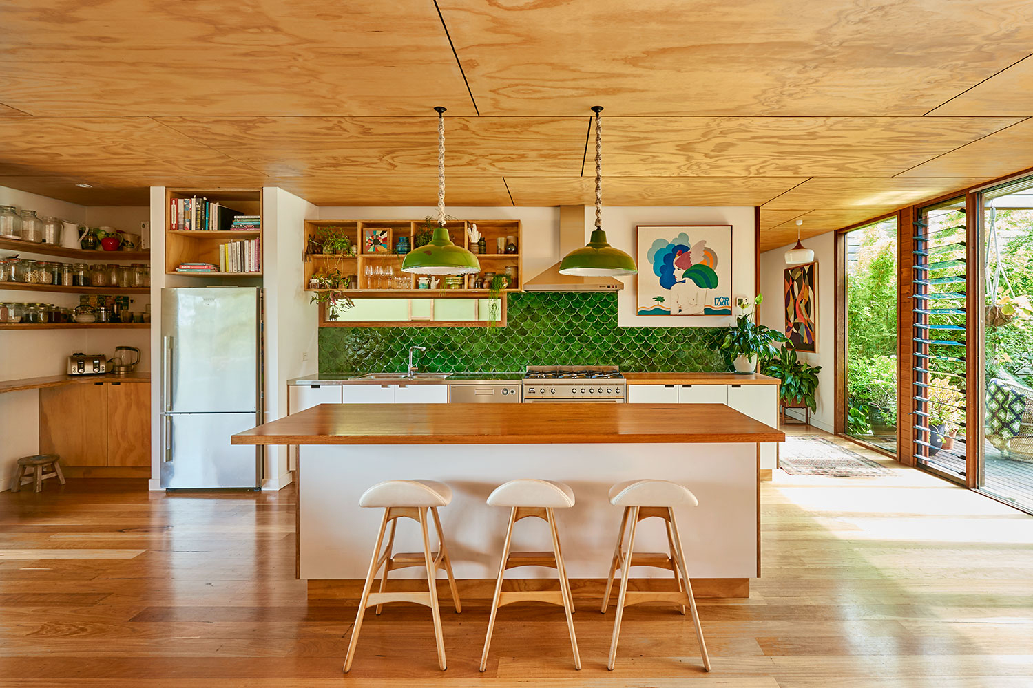 Kitchen with green backsplash