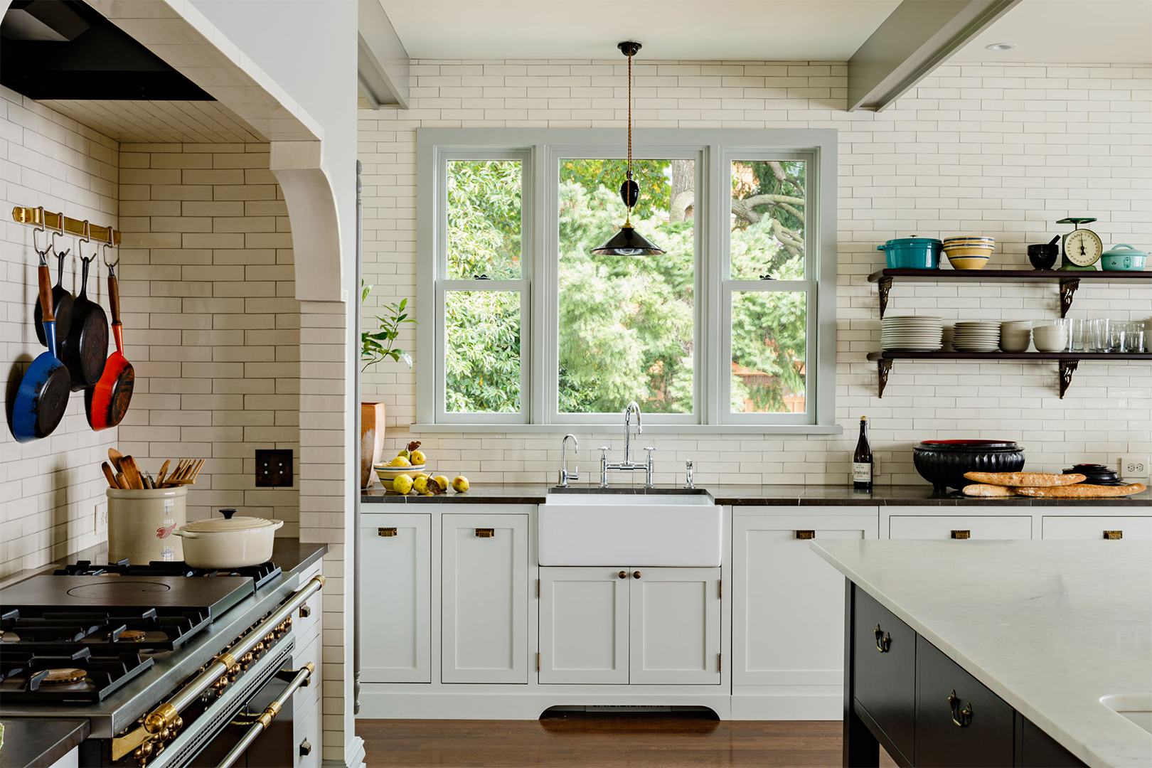 large Kitchen with farmhouse sink and modern lights