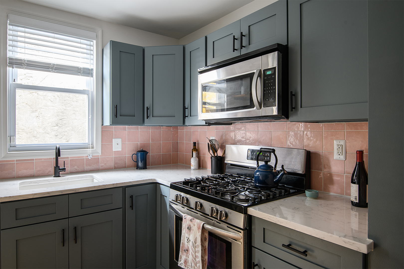 green cabinets with pink backsplash