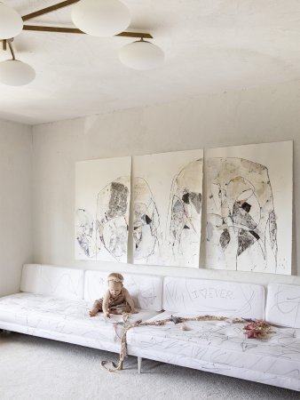 white room with baby on a white sofa