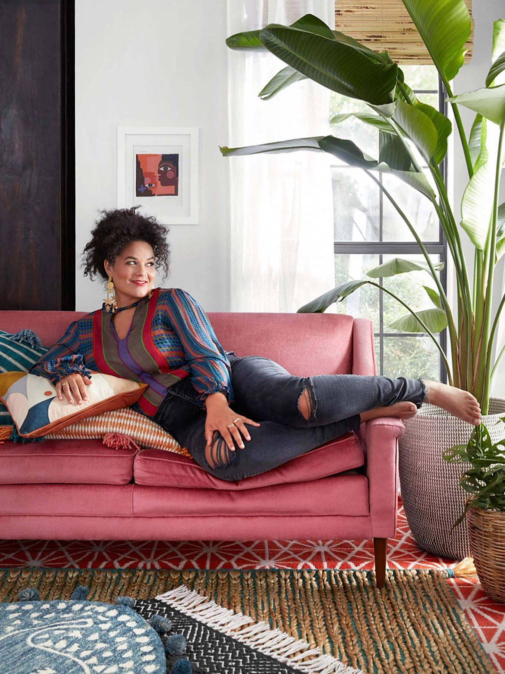 Justina Blakeney sitting on pink couch
