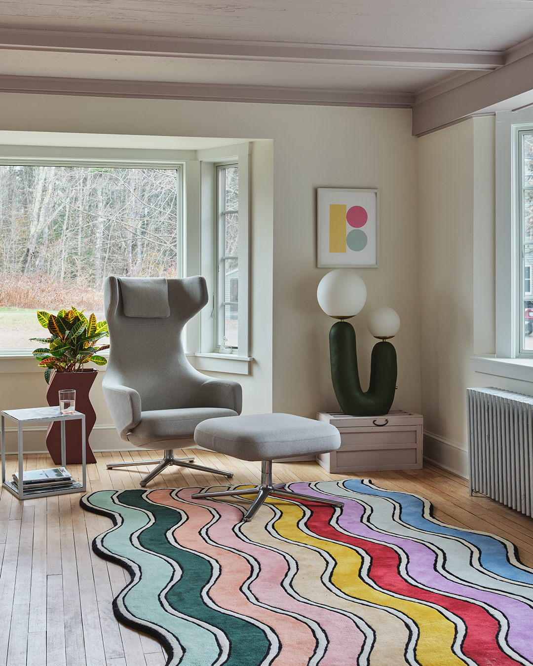 rainbow rug in a room with gray chair