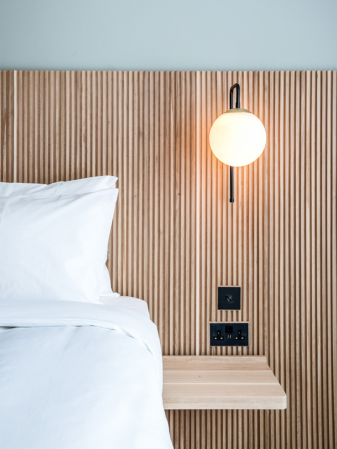 Bedroom with slatted built-in headboard