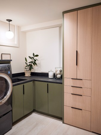 Renovated laundry room with cabinets