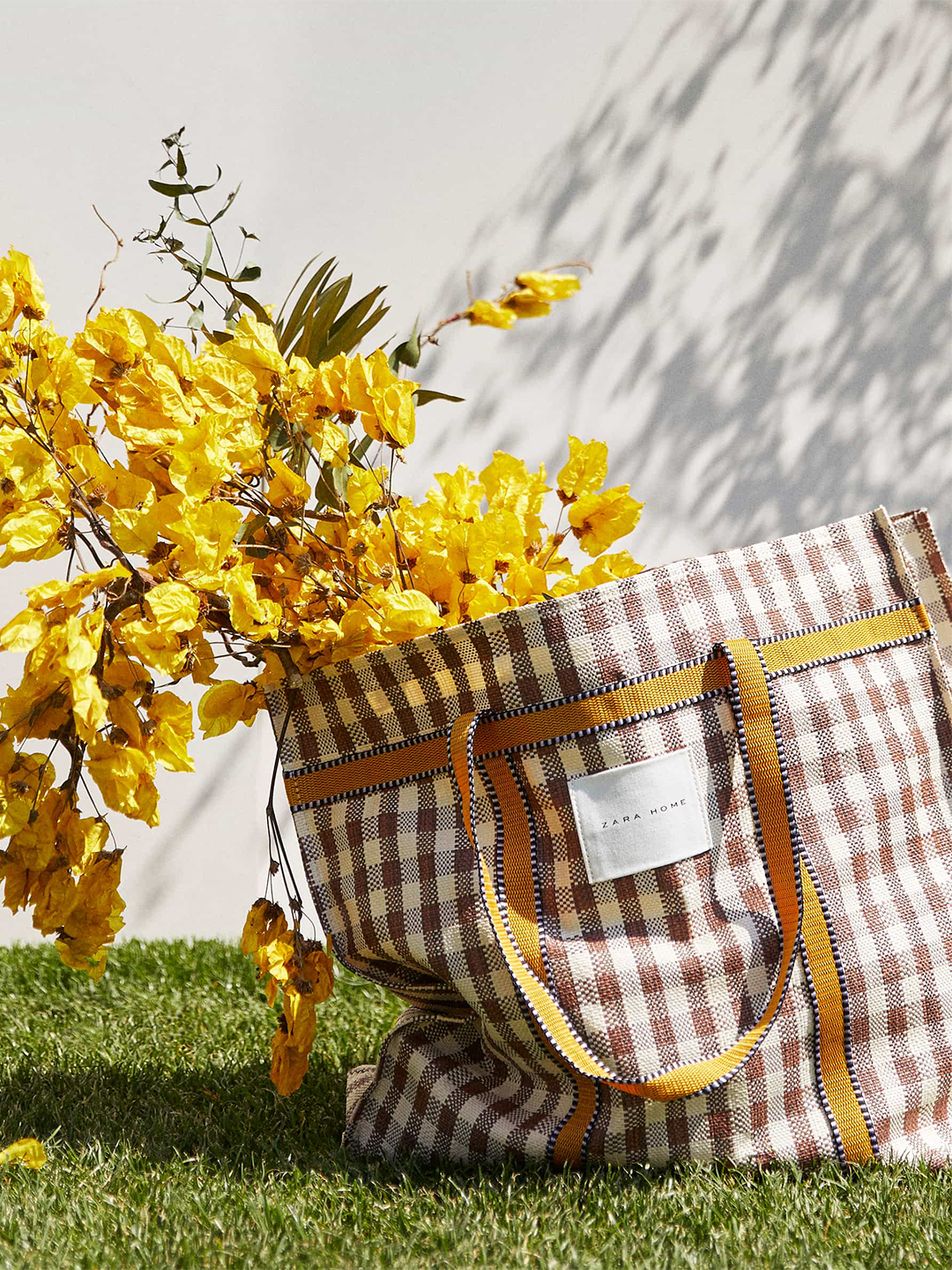 yellow flowers in a check bag