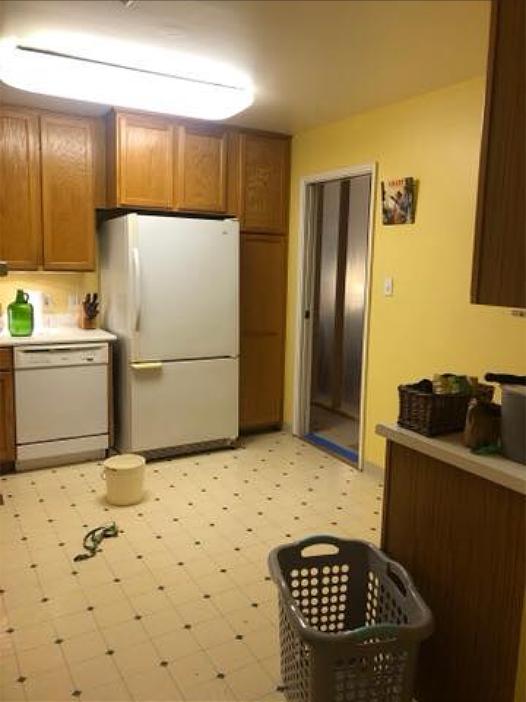 yellow and white kitchen with wood cabinets