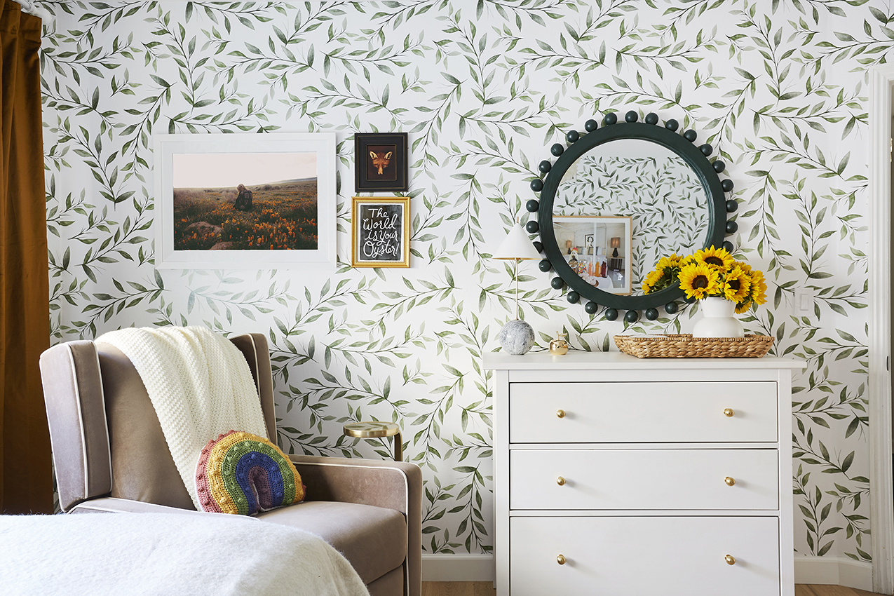 Leafy wallpaper in nursery with green mirror