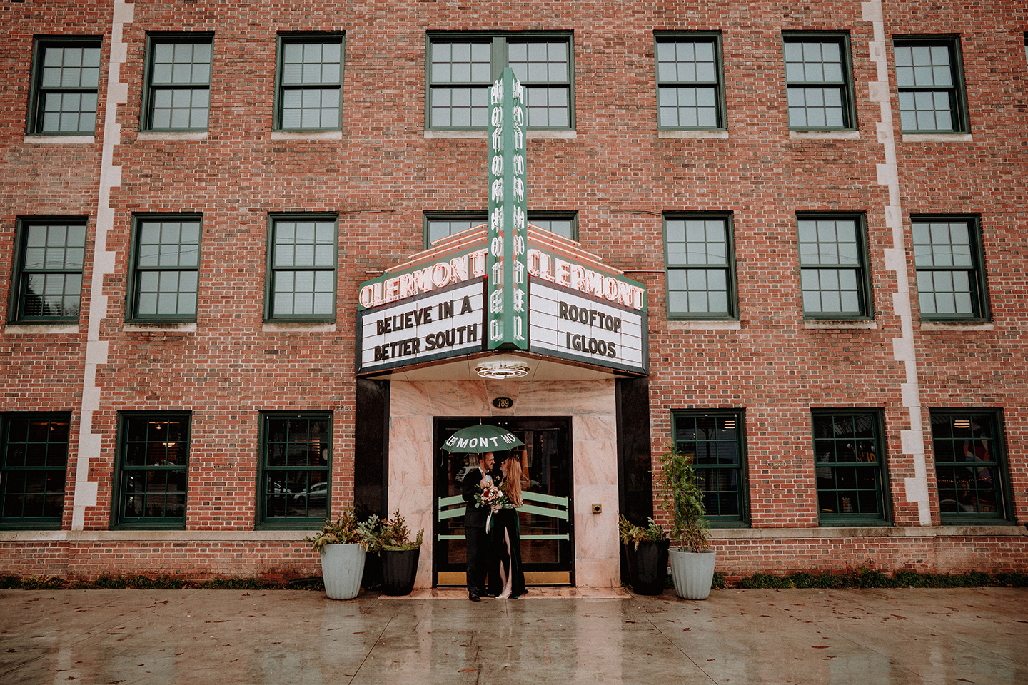 couple under a large sign