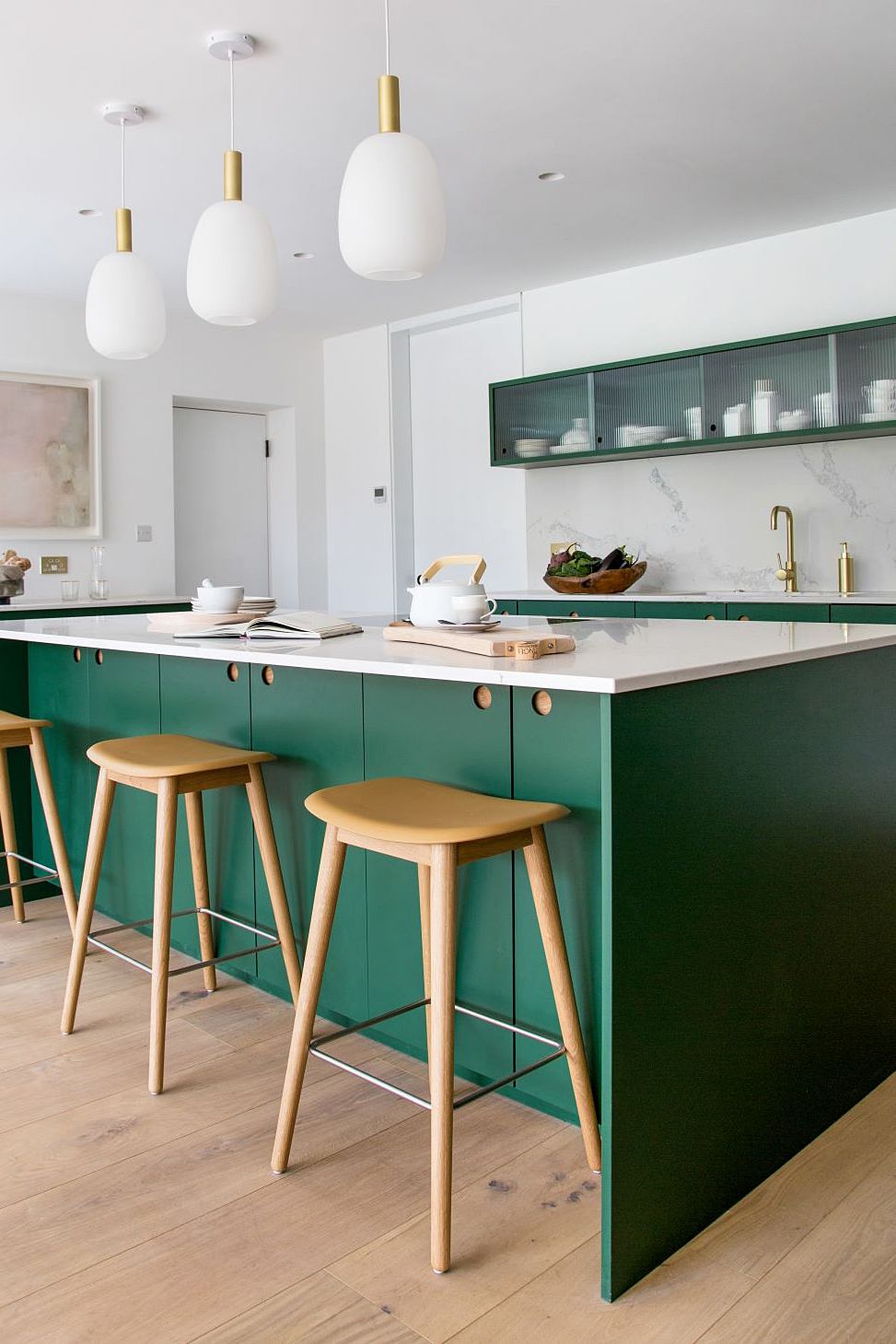 modern green kitchen with bar stools