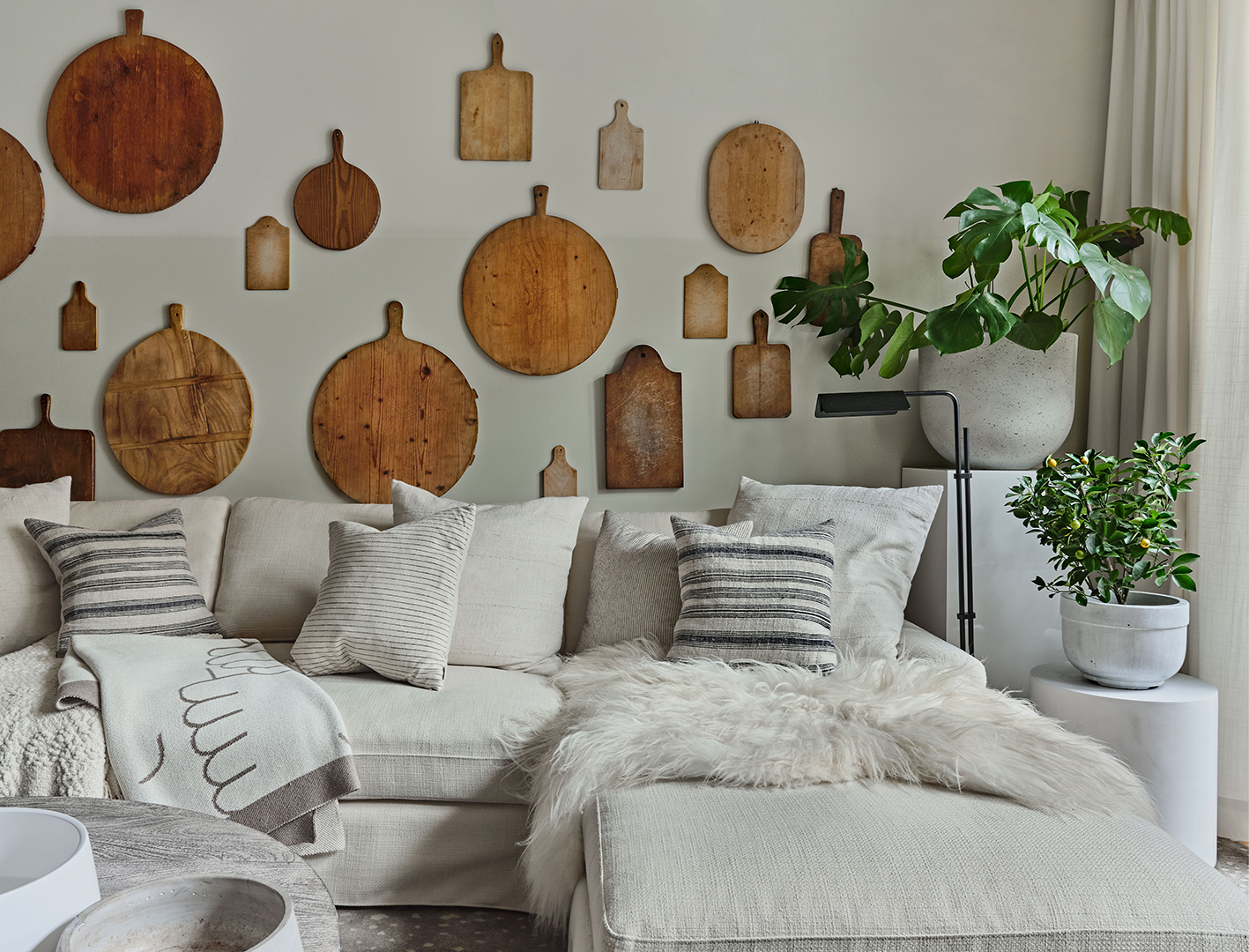 cutting board gallery wall above white sofa