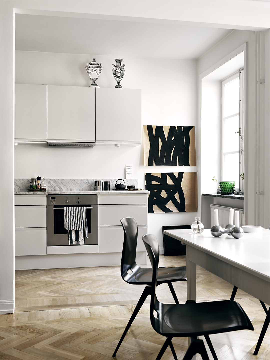 white kitchen with paper vases on top of cabinets