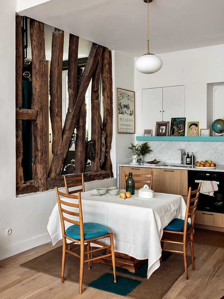 white tiny kitchen with turquoise shelf and dining space