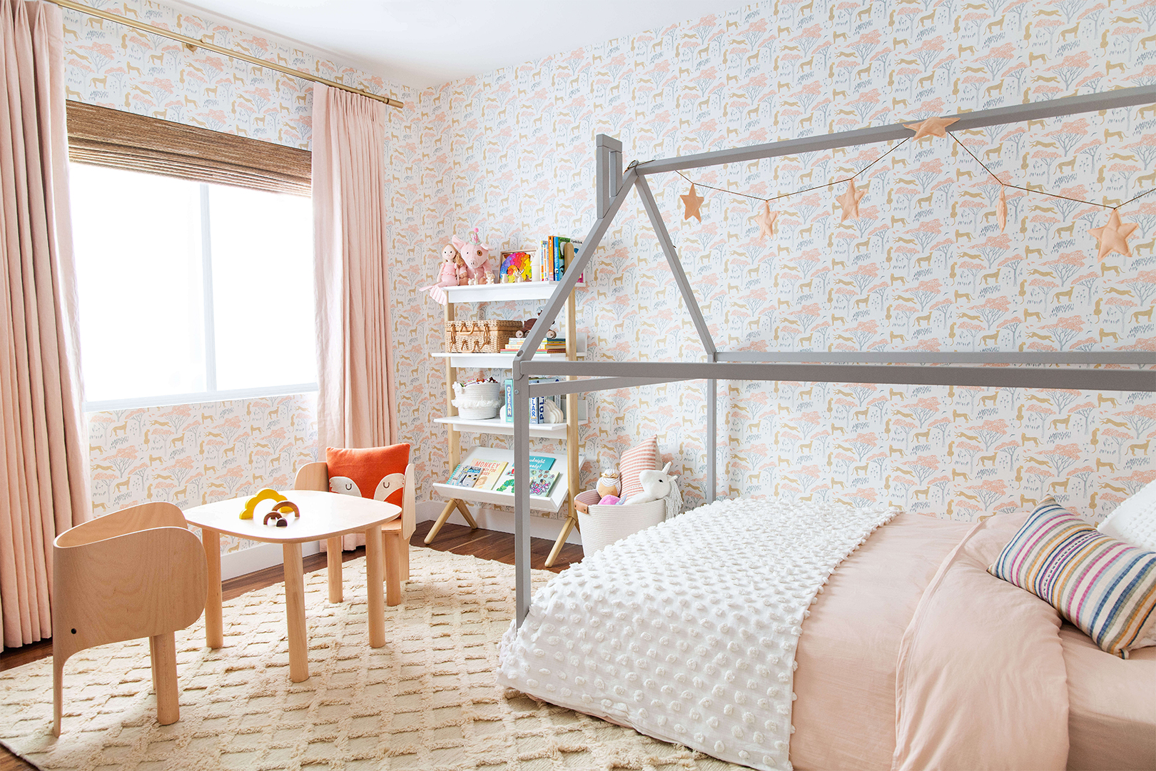 Kids room with house-shaped bed and Hygge & West wallpaper
