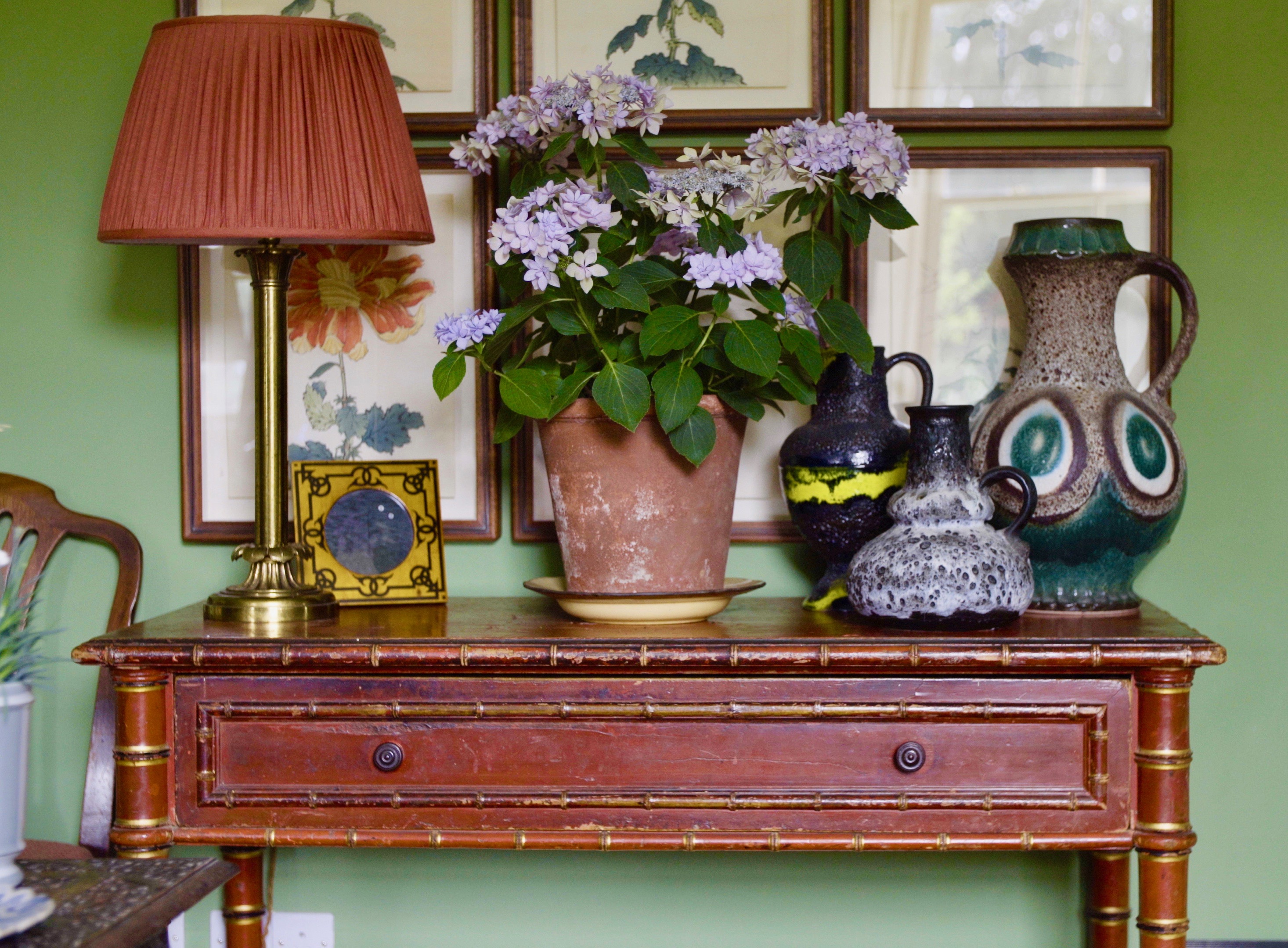 antique table in front of gallery wall