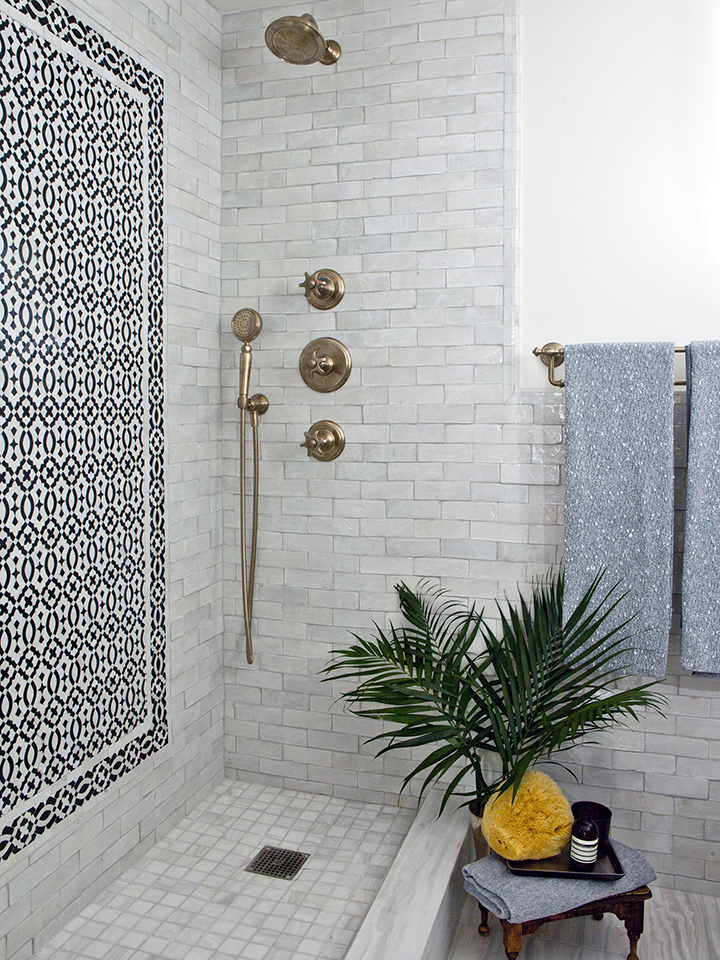 marble tile bathroom with black mosaic inlay