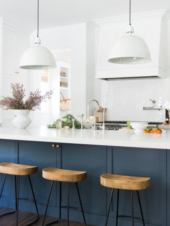 white and blue kitchen with bar stools at island