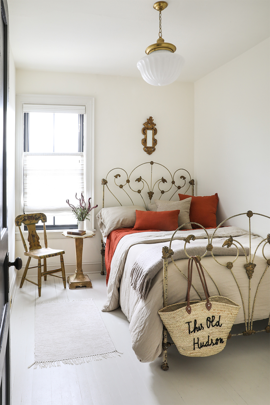 white bedroom with antique bed frame