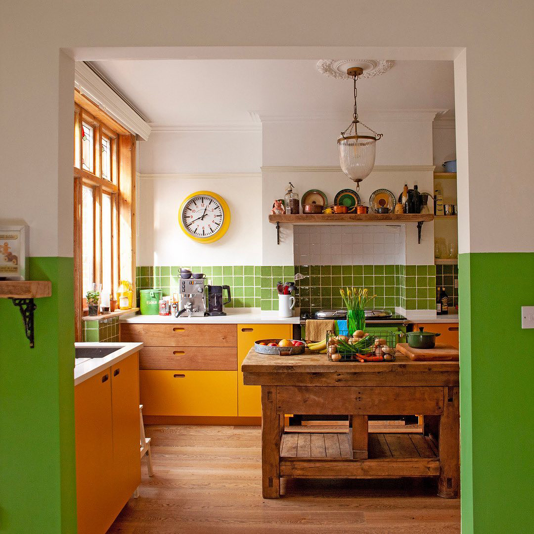Green kitchen with antique island