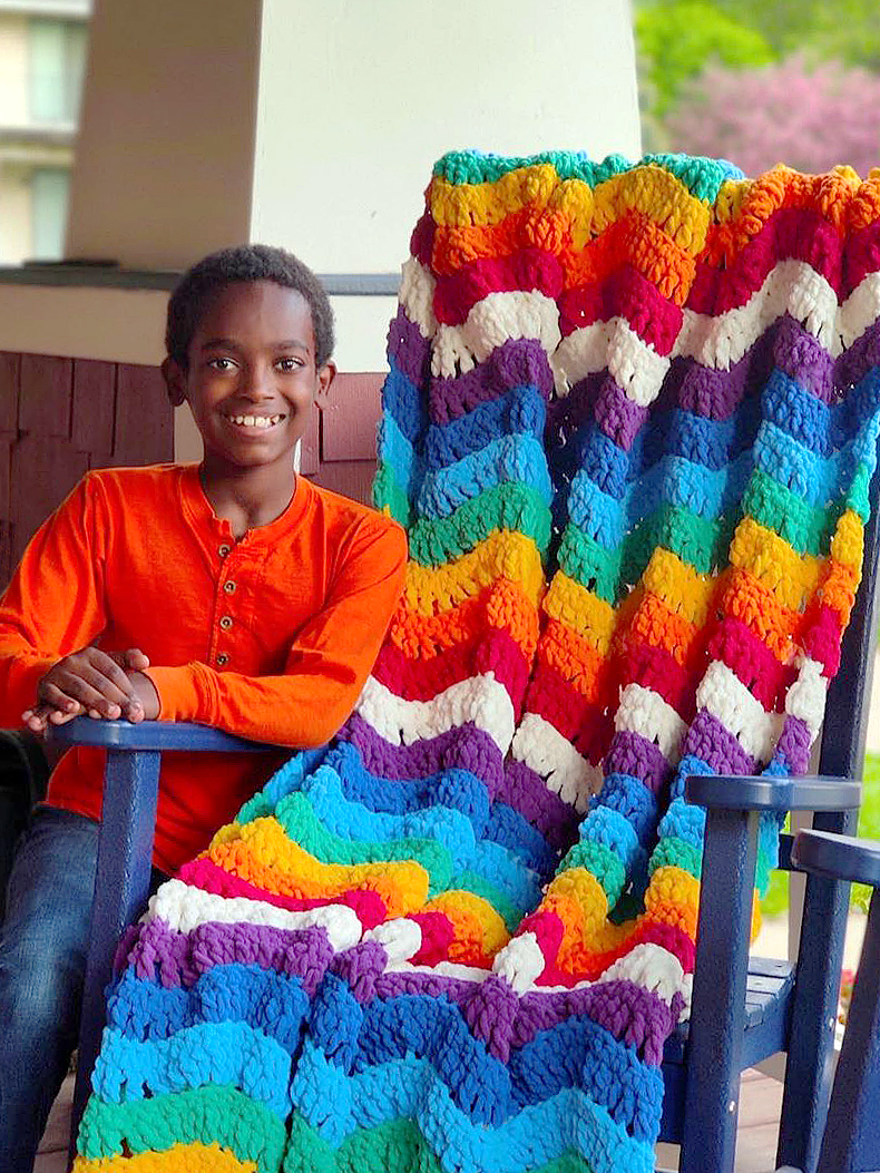 Jonah Larson and a rainbow blanket