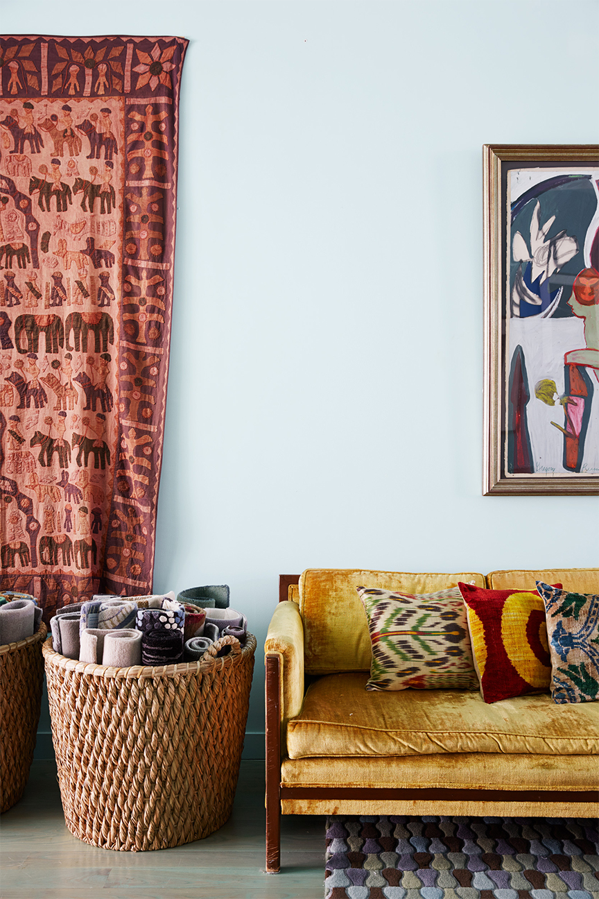 Yellow velvet sofa with colorful pillows