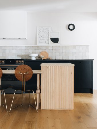 black and white kitchen with light wood island