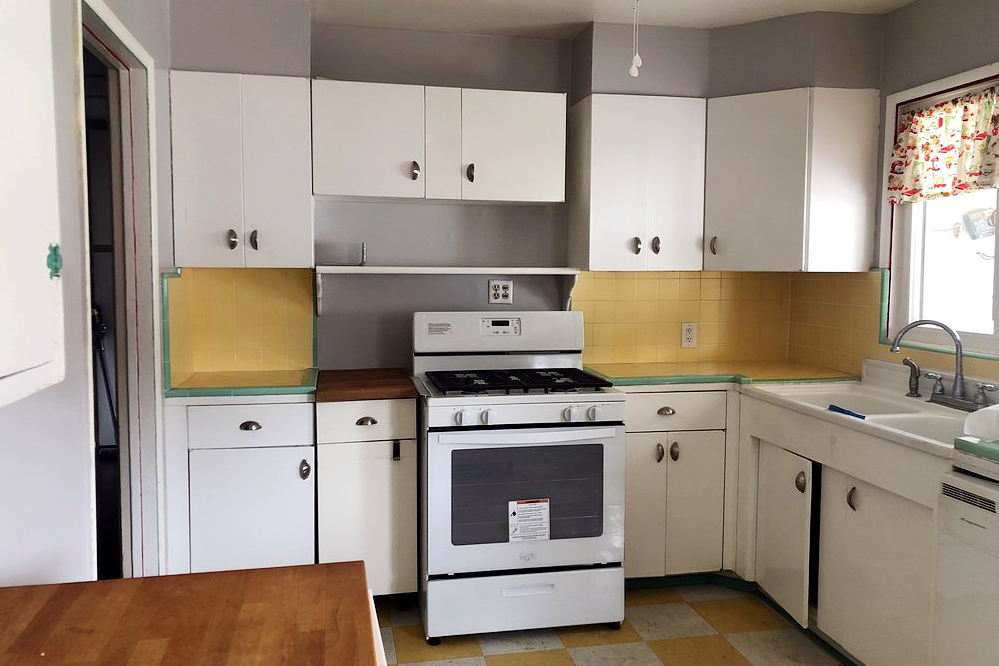 dated kitchen with linoleum checkerboard floors and yellow tile backsplash