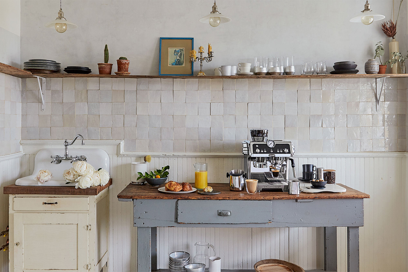 white kitchen with grey antique workbench