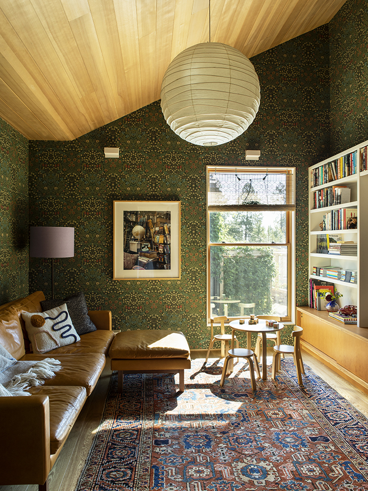 Media room with leafy wallpaper and wood ceiling