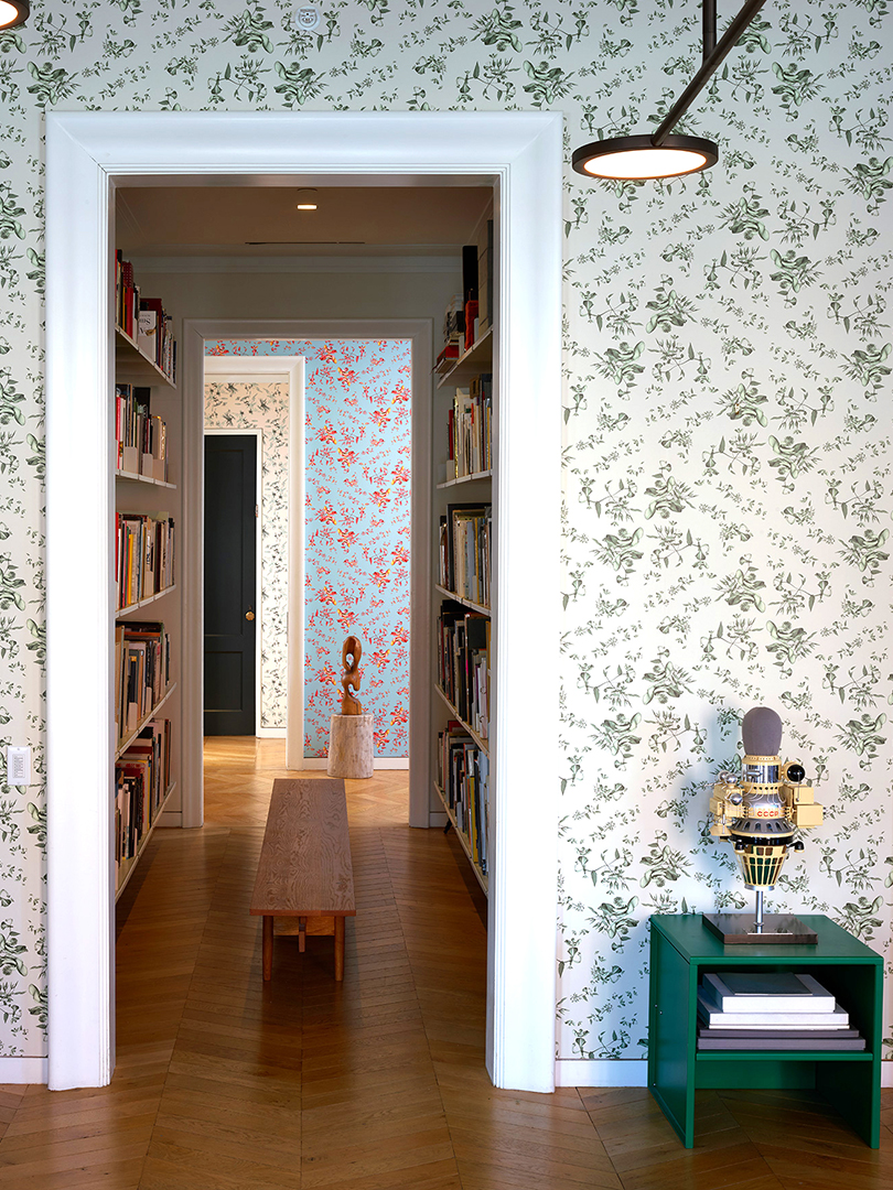 Room with leafy wallpaper and library hallway