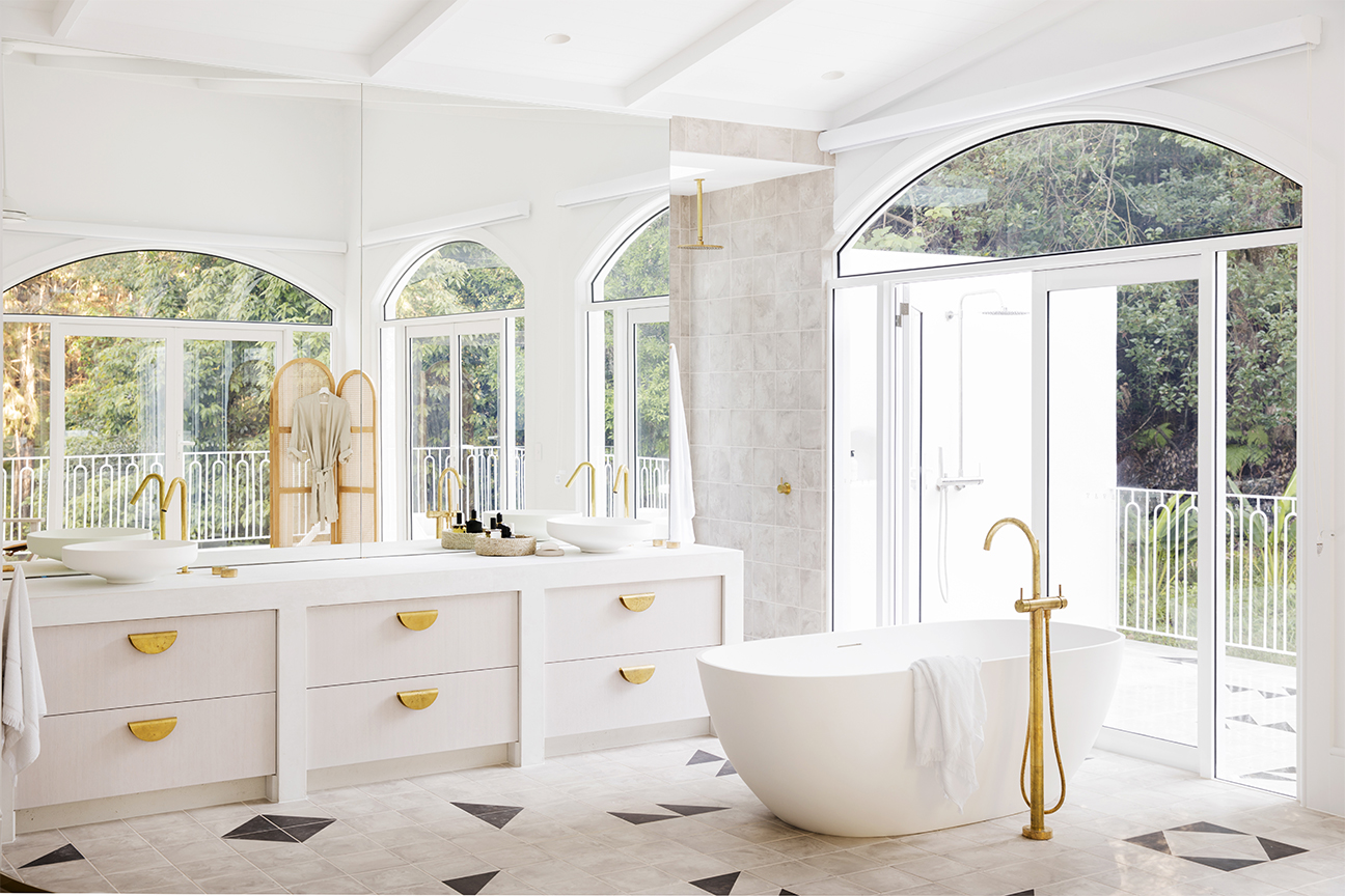 airy bathroom with black and tan floor tiles