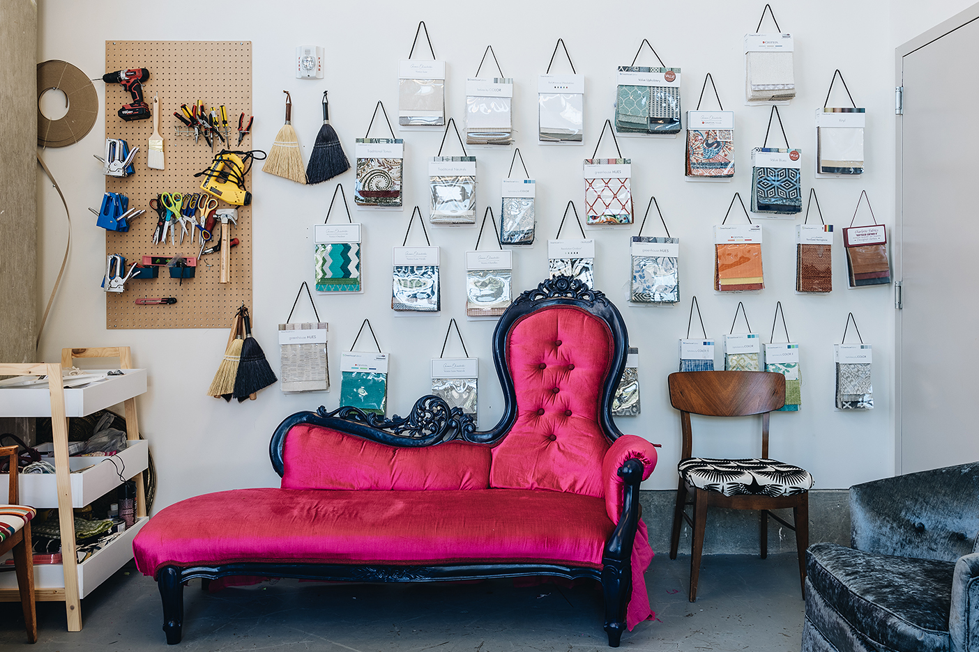 pink couch with fabric hanging on wall