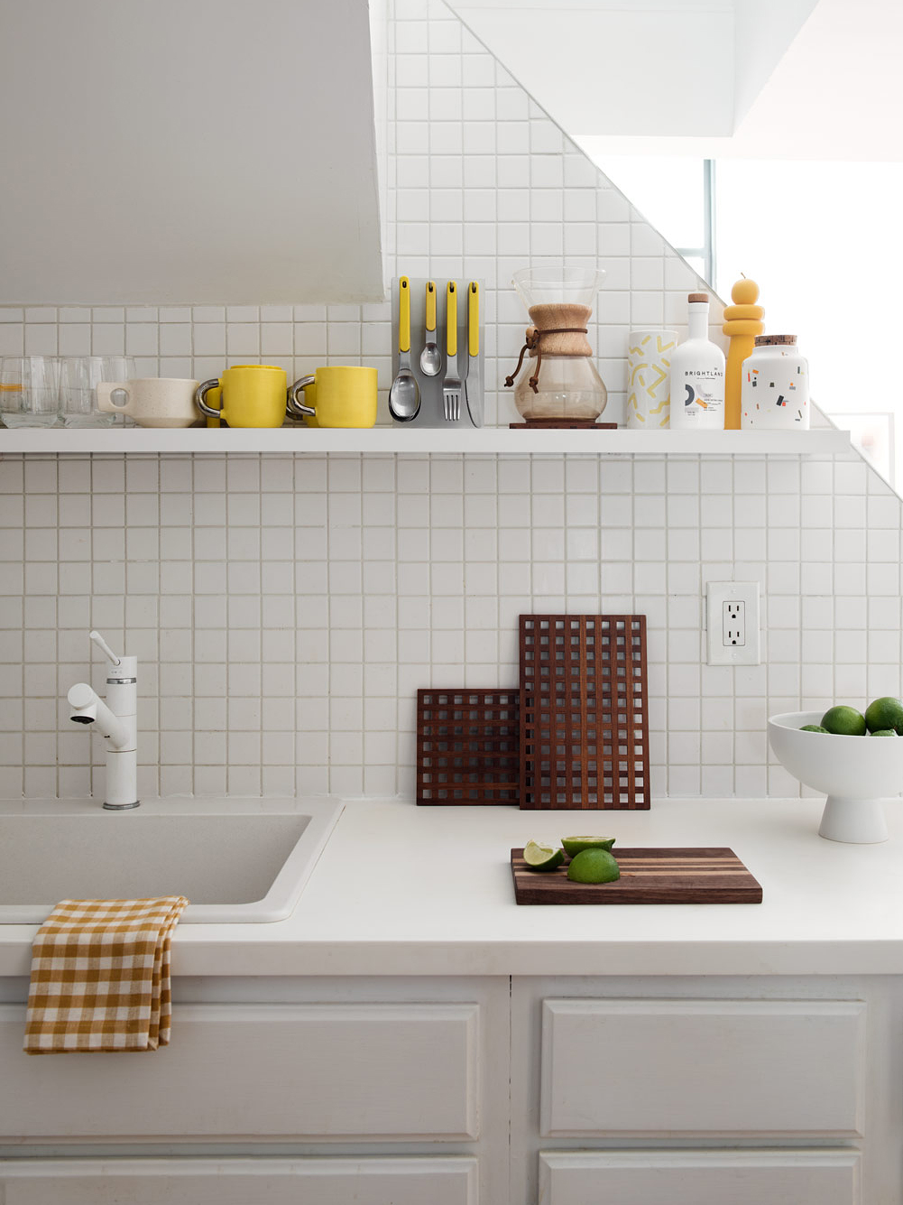 White kitchen counter with white shelf above