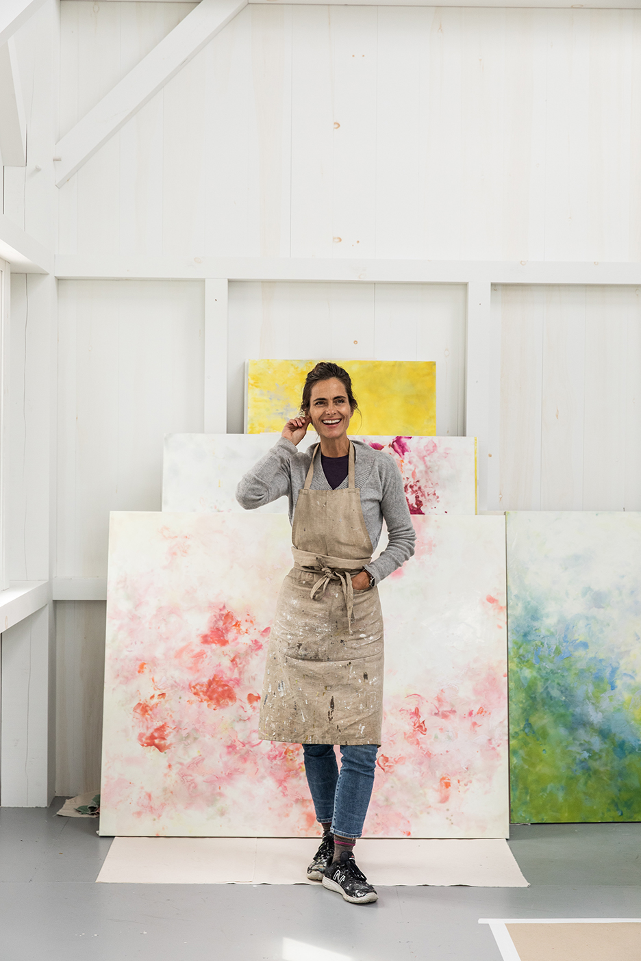 woman in front of paintings