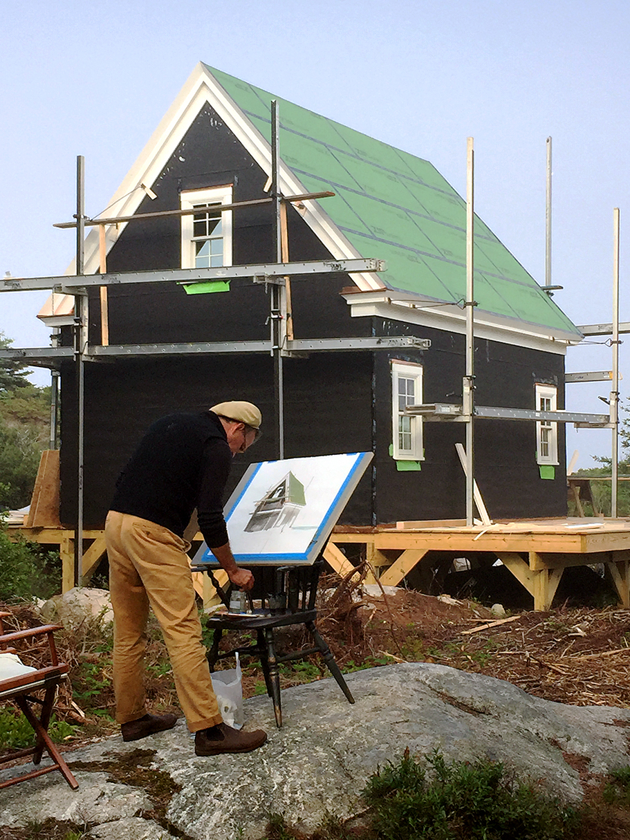 man painting construction of studio