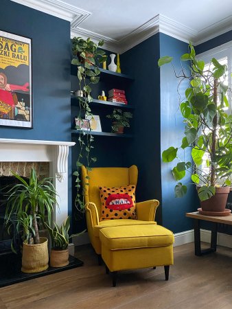 blue living room with fireplace and yellow arm chair