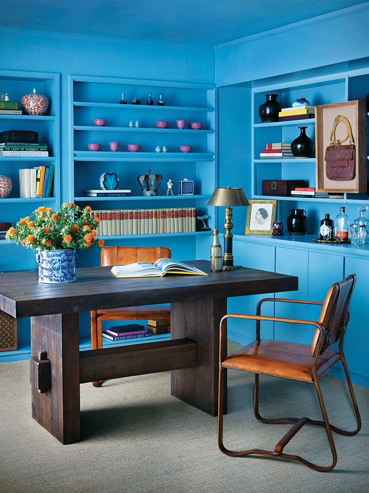 bright blue wall colors and built-in bookshelf in home office