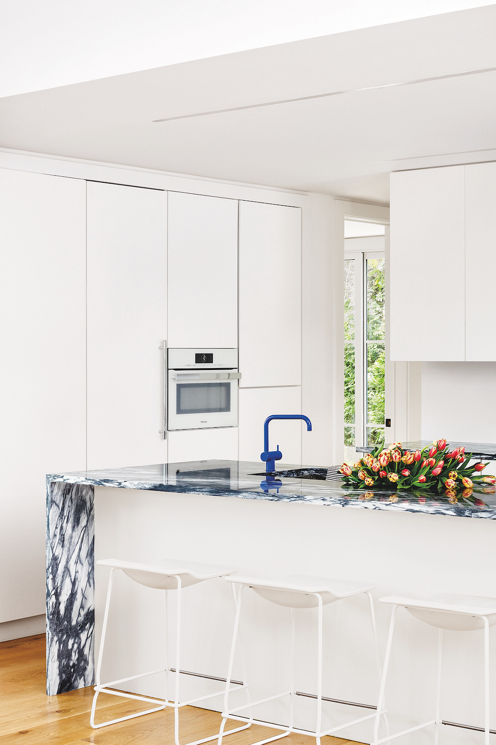 white cabinets with blue island