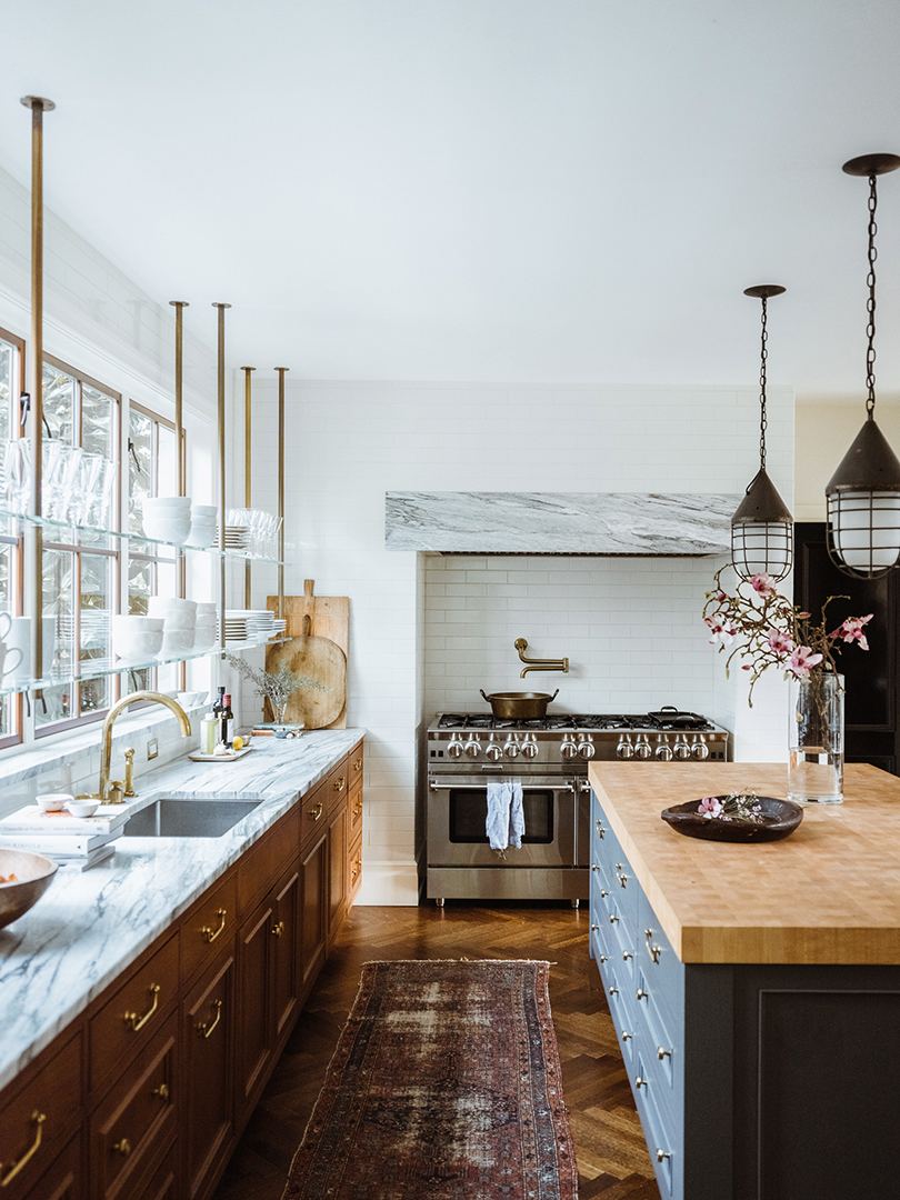 large kitchen with open shelving across windows