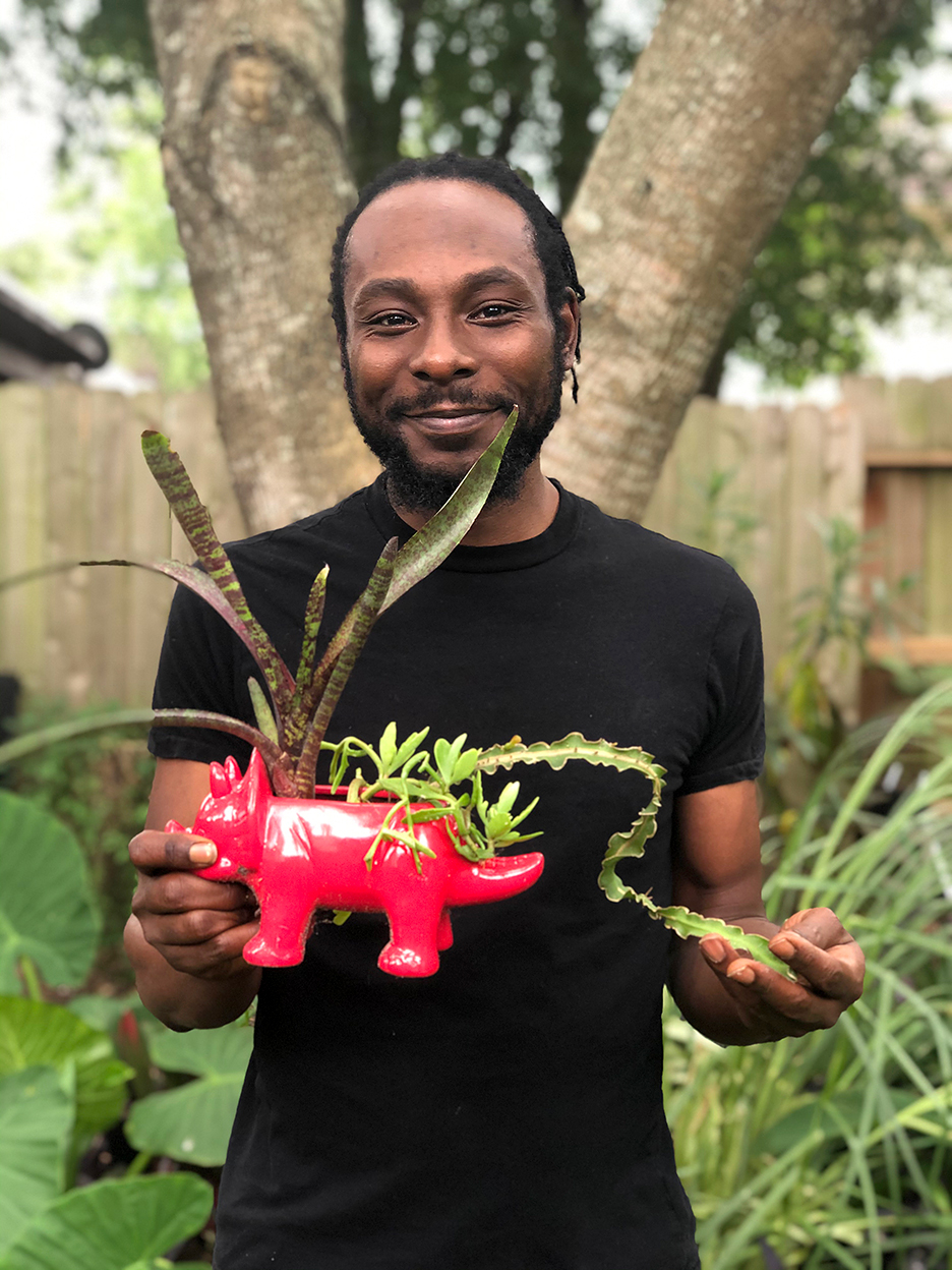 Marcus holding a plant