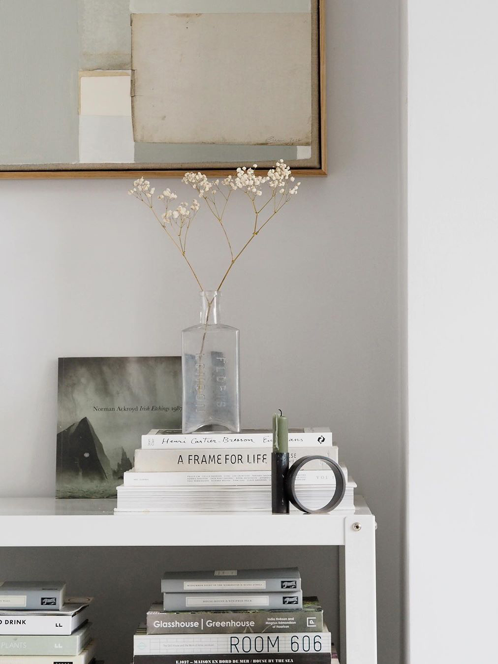 vignette of a bud vase and books