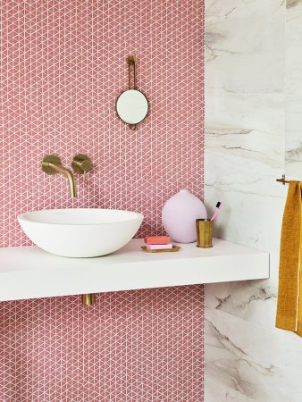 coral mosaic bathroom tile backsplash with white sink