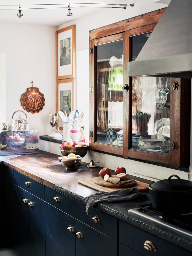 dark blue kitchen cabinets and antique upper cabinet